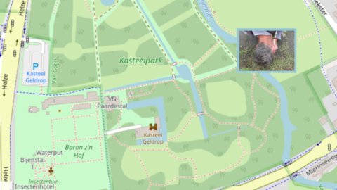 Kaart van Kasteelpark Geldrop, met kleine foto van persoon die op de grond kijkt.