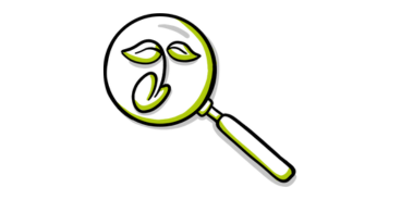 Vergrootglas met groene bladeren erin, symboliseert milieuanalyse of ecologisch onderzoek.